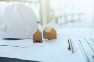 Construction and Repair work. Drawings for building Architectural project, blueprint rolls and divider compass on table. Engineering tools concept. Copyspace of Architecture and Engineer Desktop.